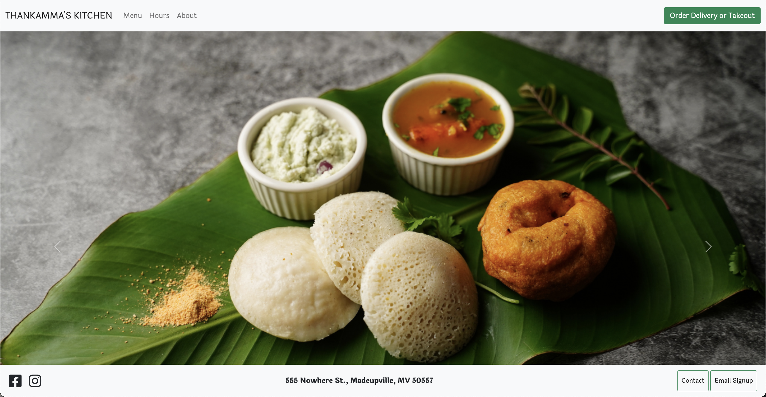 A banana leaf with idly, vadda, chutney, and sambar on top