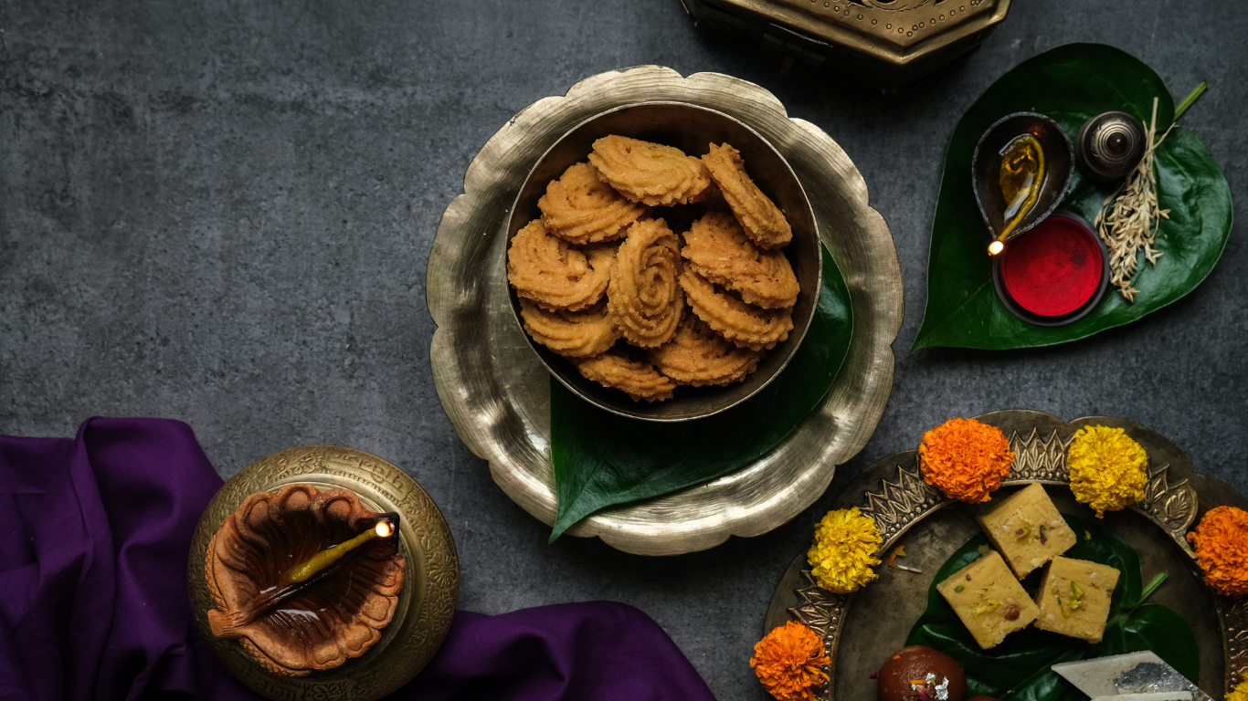 muruku displayed in a bowl surrounded by other indian desserts