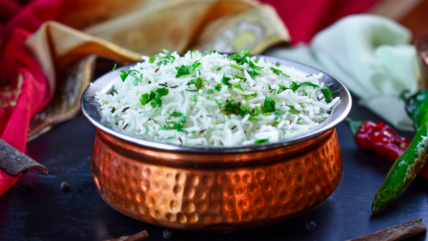 a large copper pot filled with rice